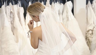 Bride inspecting her wedding dress in the mirror